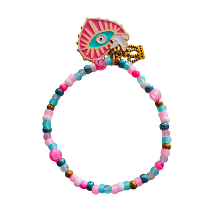 Armband met kleine kraaltjes in roze en turquiose tinten met groot hart bedel in fuchsia met blauw oog.
