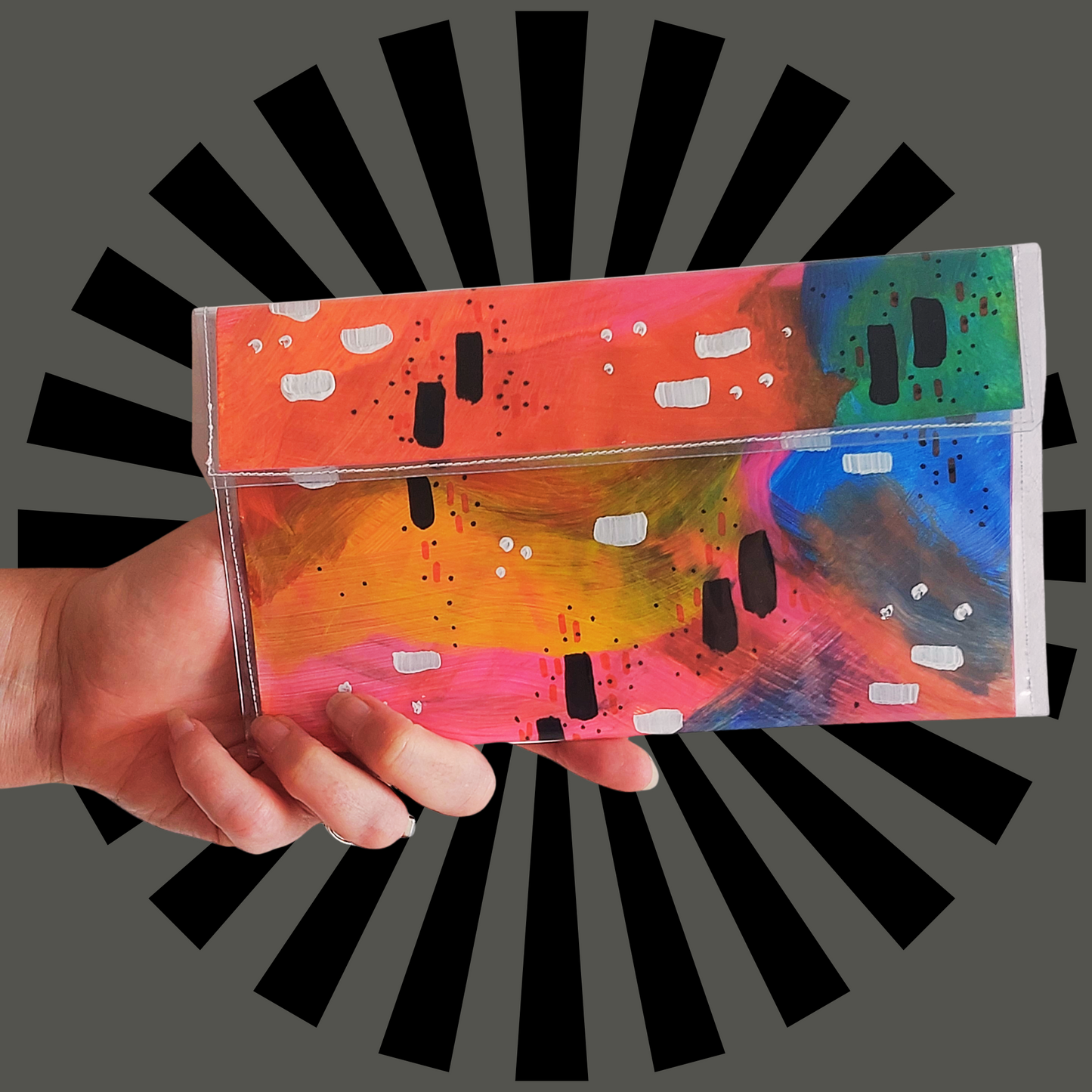 Handtas clutch van papeir en vinyl met regenboogkleuren in abstract patroon, sfeerbeeld